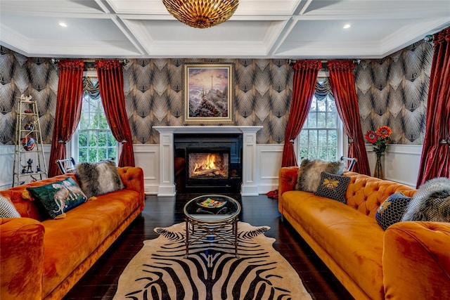 living area with a warm lit fireplace, wallpapered walls, and coffered ceiling