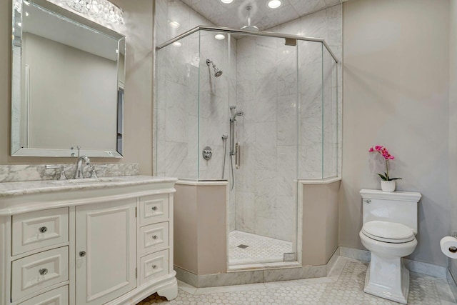 full bathroom with a shower stall, baseboards, toilet, tile patterned floors, and vanity
