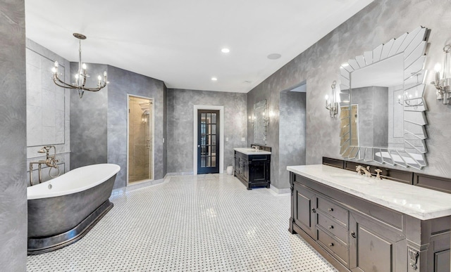 full bathroom featuring a soaking tub, a sink, and an inviting chandelier