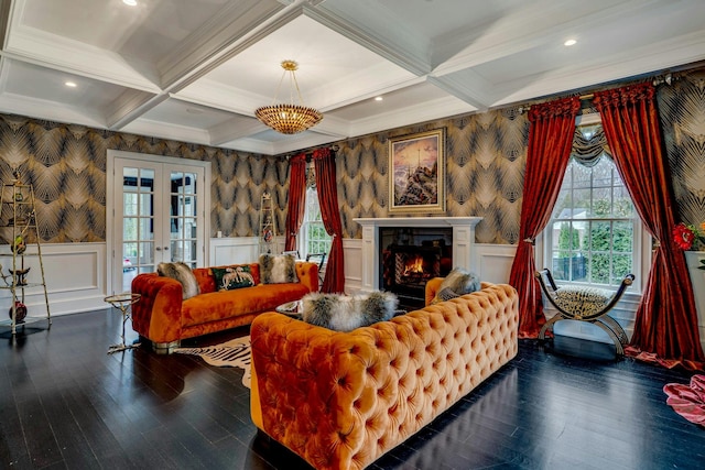 living room with a wealth of natural light, wallpapered walls, wainscoting, and beam ceiling