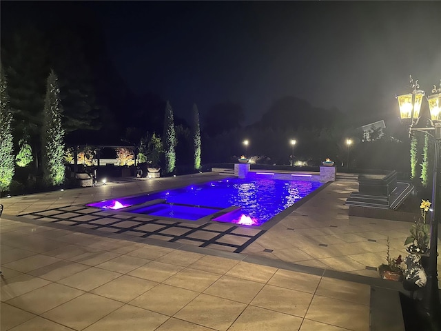 pool at night with a patio