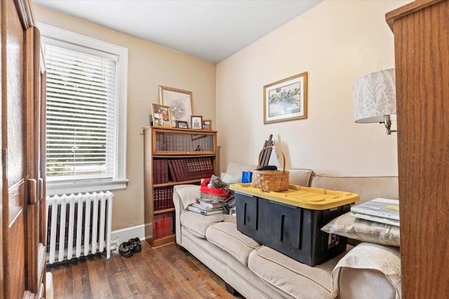 office area featuring radiator, wood finished floors, and baseboards