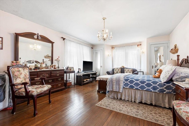 bedroom with a notable chandelier and hardwood / wood-style flooring