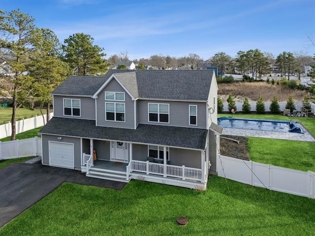 view of front of home with a porch, a front yard, a fenced backyard, and aphalt driveway