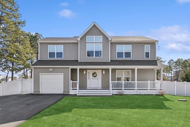 view of front of home featuring aphalt driveway, covered porch, a front yard, fence, and a garage