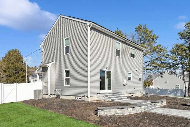 back of house featuring cooling unit, a gate, and fence