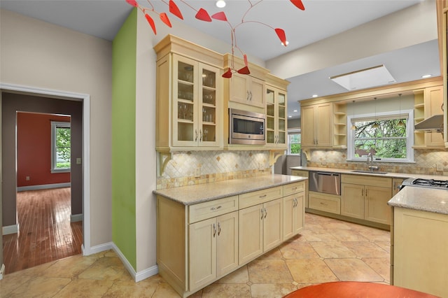 6 Agate Ave, Ossining, NY 10562 - kitchen with open shelves, stainless steel appliances, a sink, backsplash, and glass insert cabinets