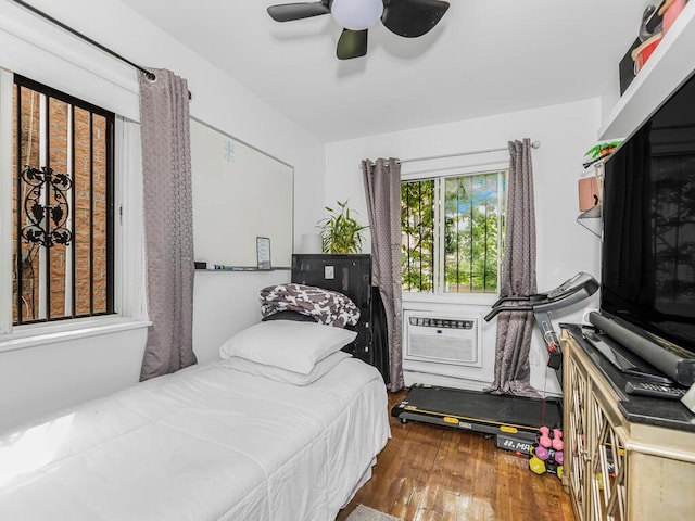 bedroom with hardwood / wood-style flooring, cooling unit, and a ceiling fan