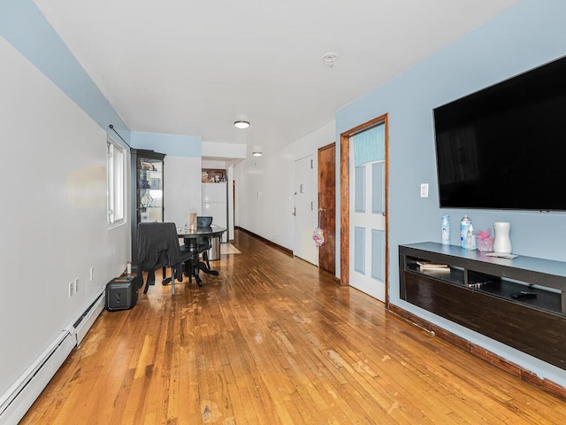 interior space with light wood-style floors and a baseboard radiator