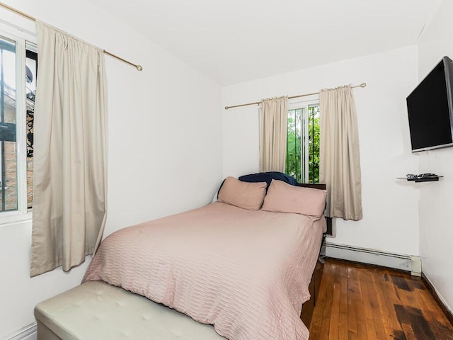 bedroom featuring a baseboard radiator and wood-type flooring