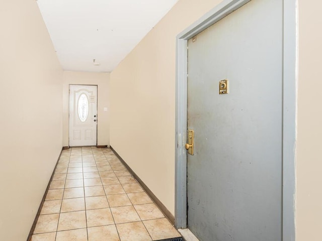 entryway featuring light tile patterned floors and baseboards