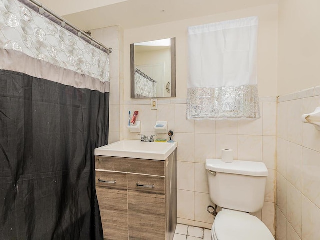 full bathroom featuring toilet, tile walls, and vanity