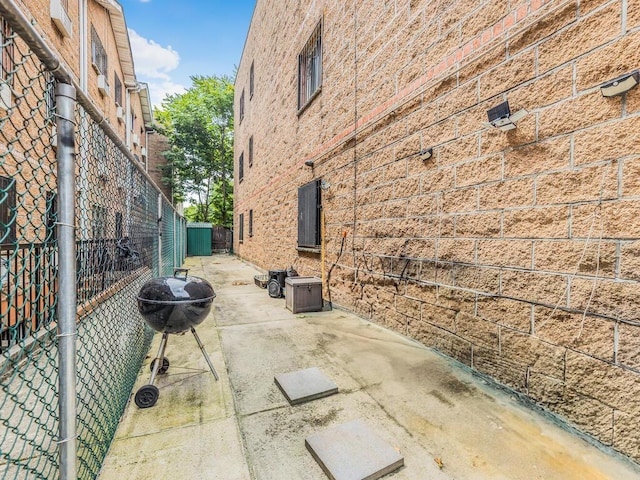 view of patio / terrace featuring a grill and fence