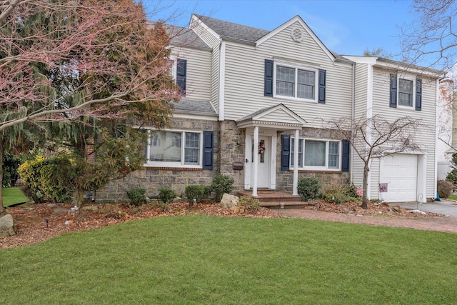 view of front of property with roof with shingles, a garage, stone siding, driveway, and a front lawn