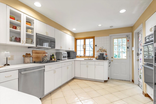 kitchen with black appliances, light countertops, and decorative backsplash