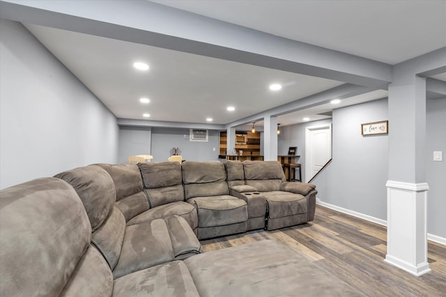 living area with baseboards, an AC wall unit, wood finished floors, and recessed lighting