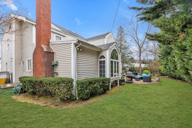 view of property exterior featuring a chimney, an outdoor hangout area, a lawn, and a patio