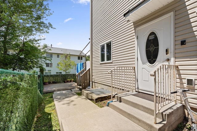 view of exterior entry with a wooden deck