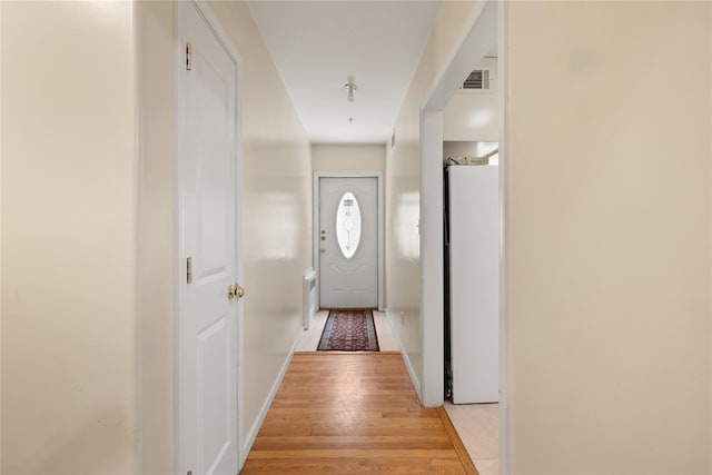 entryway with light wood-style floors, visible vents, and baseboards