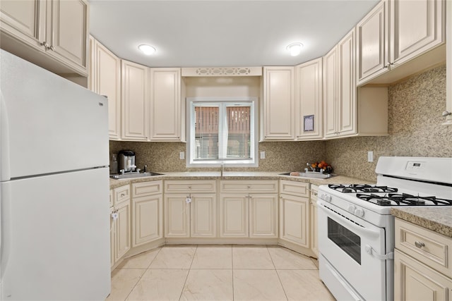 kitchen featuring white appliances, light countertops, and cream cabinetry