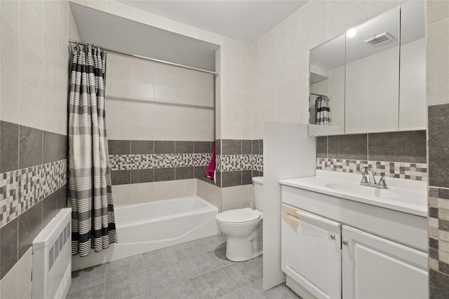 full bath featuring tile walls, tasteful backsplash, shower / bath combination with curtain, radiator heating unit, and vanity