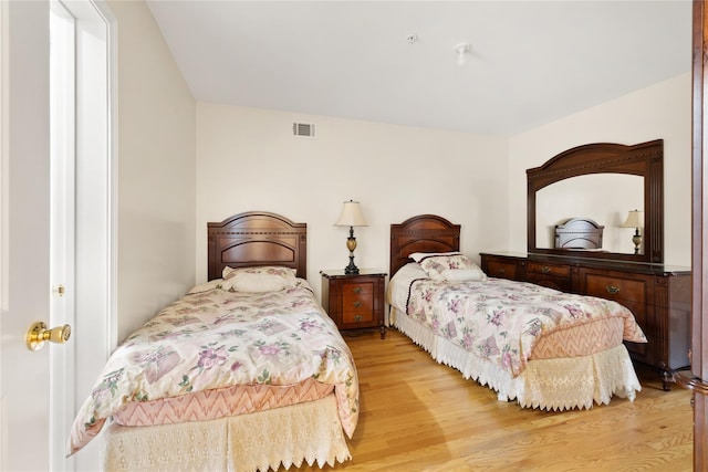 bedroom featuring visible vents and light wood-style floors