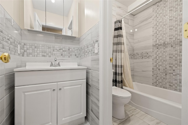 full bath featuring toilet, shower / bathtub combination with curtain, tile walls, and vanity