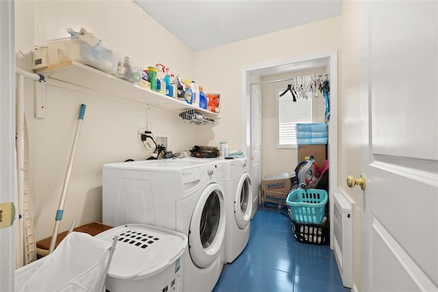 clothes washing area with laundry area, dark tile patterned floors, and washing machine and clothes dryer