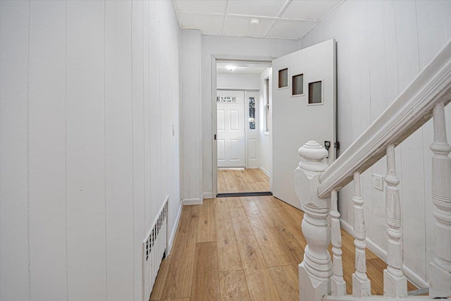 corridor featuring light wood-type flooring, visible vents, and stairs