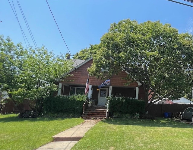 bungalow-style home featuring a front lawn