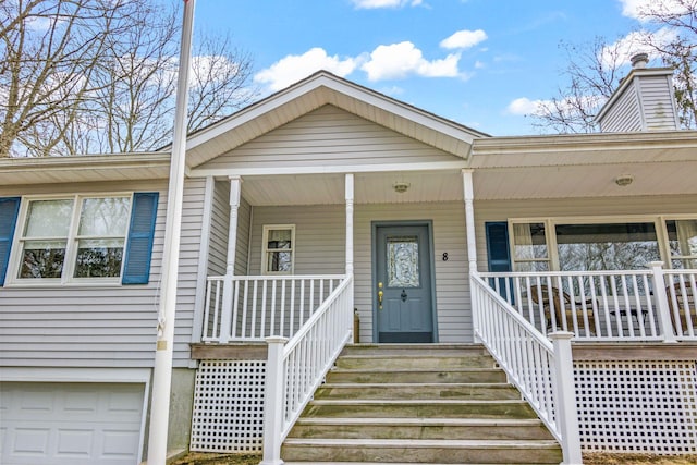 8 Rolling Woods Ln, Hampton Bays, NY 11946 - entrance to property featuring a porch and an attached garage
