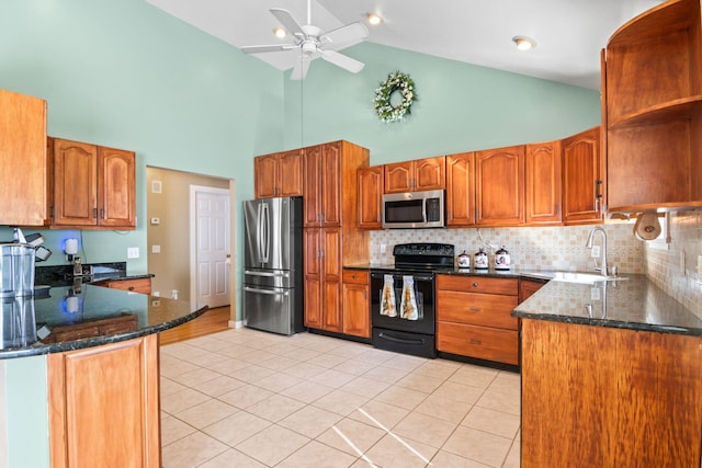 8 Rolling Woods Ln, Hampton Bays, NY 11946 - kitchen featuring appliances with stainless steel finishes, high vaulted ceiling, dark stone counters, light tile patterned floors, and a ceiling fan