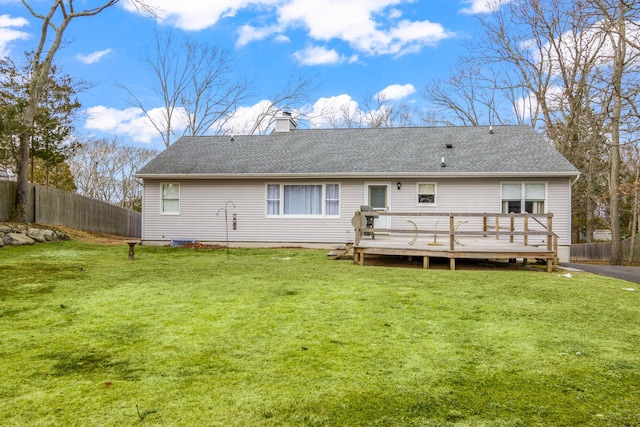 8 Rolling Woods Ln, Hampton Bays, NY 11946 - rear view of house with a chimney, a deck, and a shingled roof