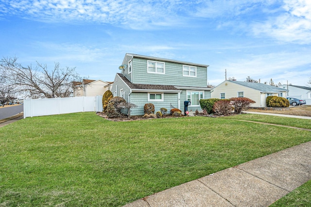 view of front of home featuring fence and a front yard