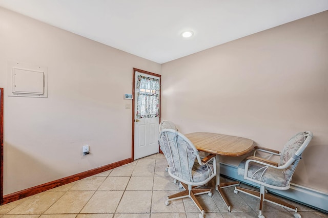 dining room featuring light tile patterned flooring and baseboards