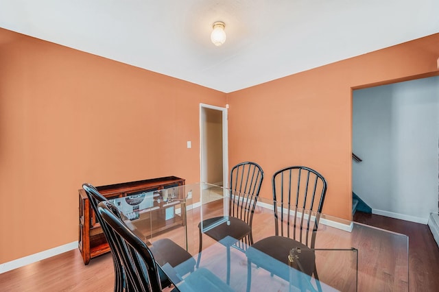 dining room with baseboards and wood finished floors