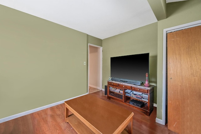 living room with baseboards and wood finished floors