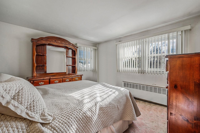 bedroom featuring radiator and carpet flooring