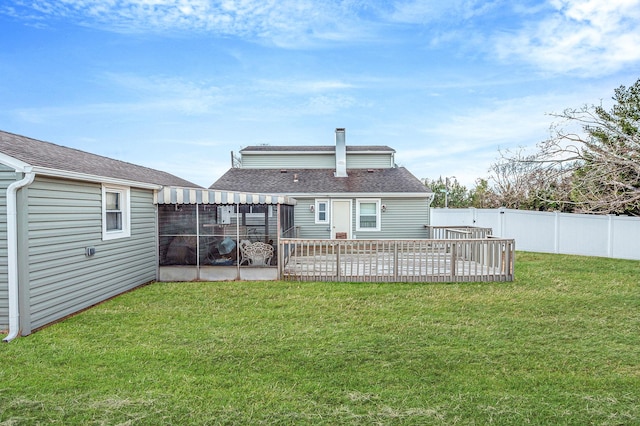 rear view of house with a patio, a yard, roof with shingles, and a fenced backyard