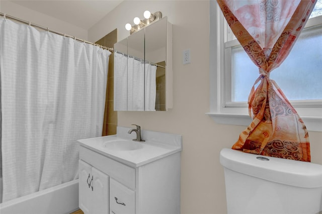 full bath with shower / bath combo, vanity, and toilet