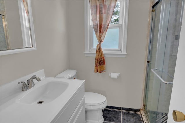 bathroom featuring tile patterned flooring, a tile shower, vanity, and toilet