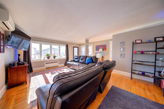 living room featuring light wood-style flooring, radiator, an AC wall unit, and baseboards