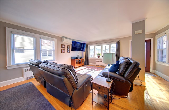 living area featuring baseboards, light wood-style flooring, and radiator heating unit