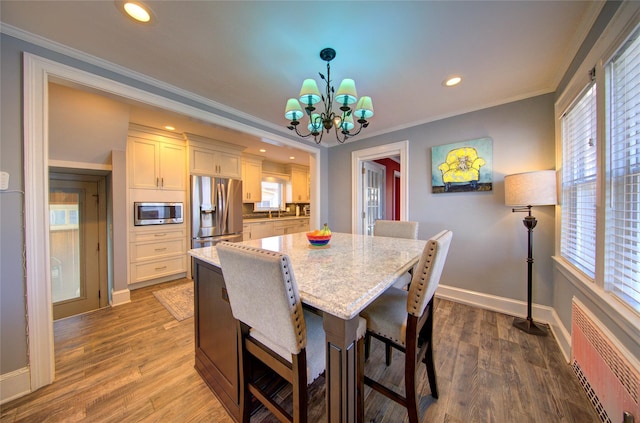 dining space featuring recessed lighting, baseboards, ornamental molding, dark wood-style floors, and radiator heating unit