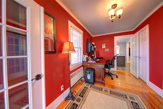 office area with wood finished floors, baseboards, french doors, radiator heating unit, and crown molding