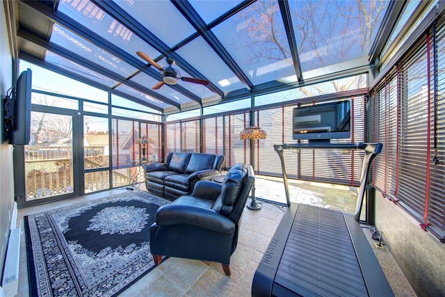 sunroom featuring a ceiling fan