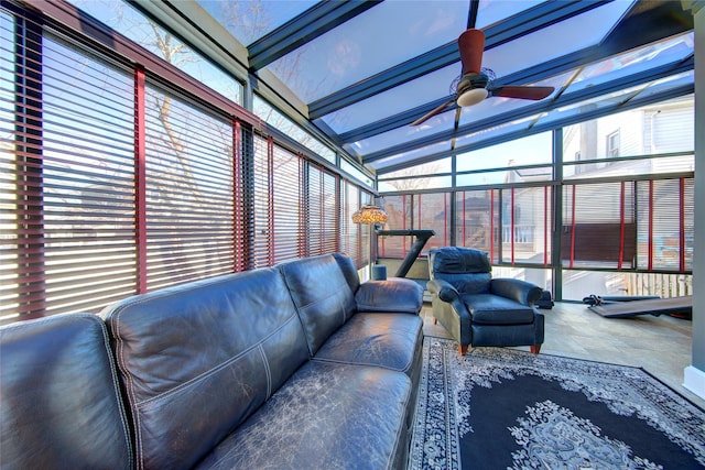 sunroom with lofted ceiling and a ceiling fan