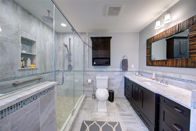 full bath featuring tile walls, visible vents, radiator heating unit, a shower stall, and vanity