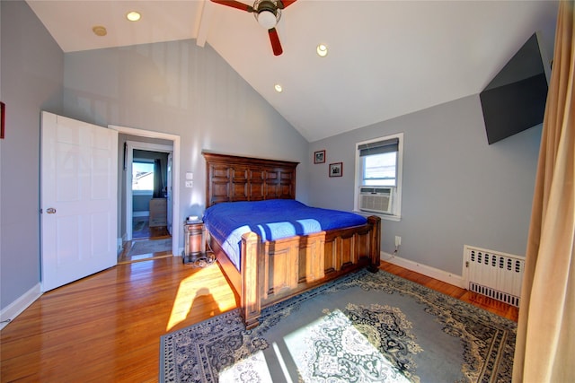 bedroom with baseboards, radiator heating unit, wood finished floors, beamed ceiling, and high vaulted ceiling