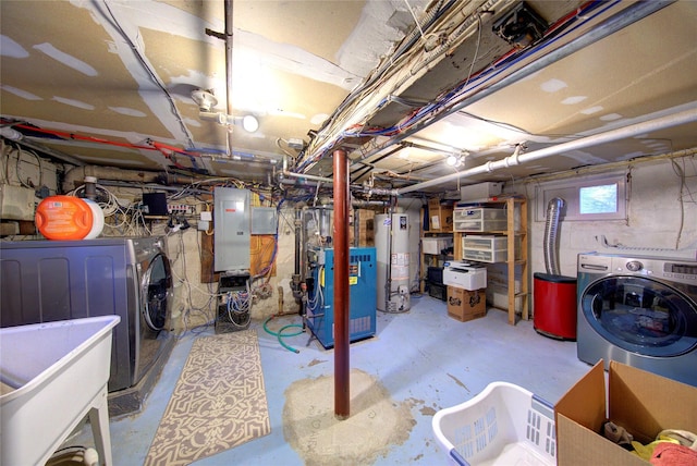 below grade area featuring washing machine and dryer, water heater, a sink, and a heating unit